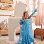Girl in a blue princess dress with a tiara playing with Possum Play Couch and Tunnels & Shields Set - active screen-free play