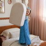 Girl in a blue dress lifting Possum Play Tunnels & Shield Set pieces - imaginary screen free play time