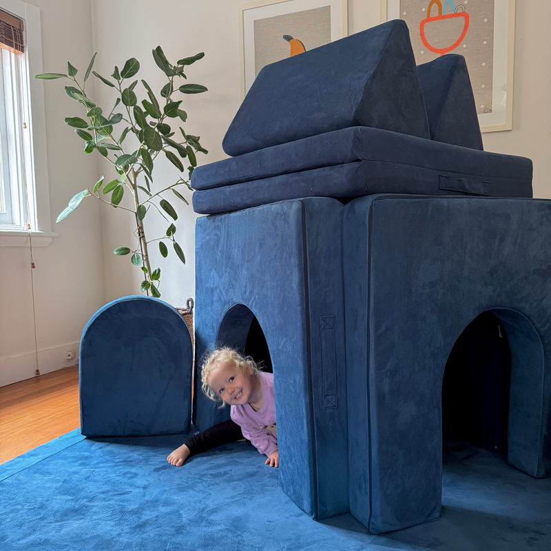 Possum Play Tunnels & Shields in Sailor — siblings crawling through foam arch tunnels in a large castle fort build